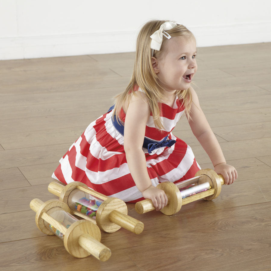 Set of wooden cylindrical rollers filled with items