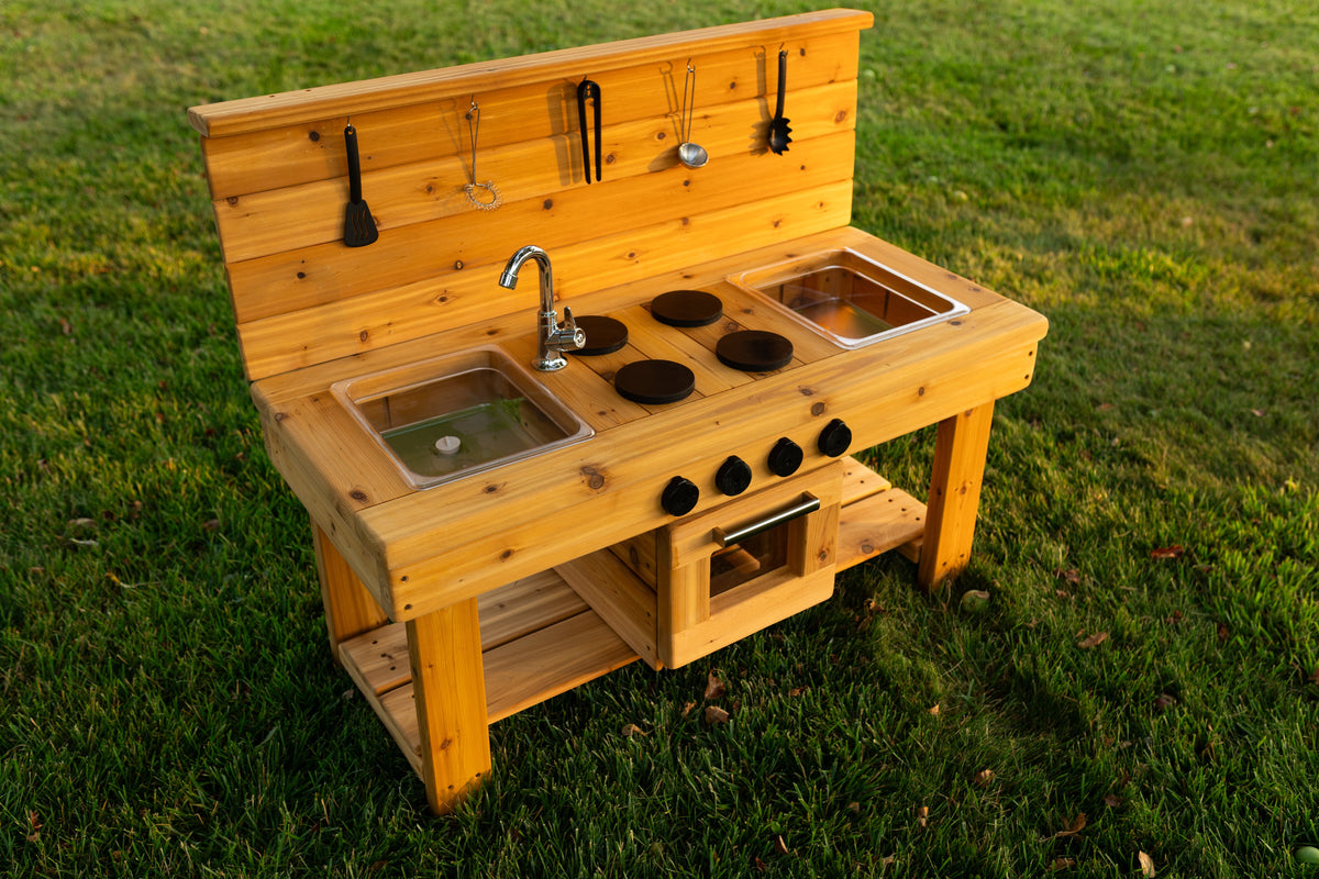 Cedar outdoor mud kitchen by Noble Wooden Toys with oven, stovetop, working faucet and 2 centred clear sinks