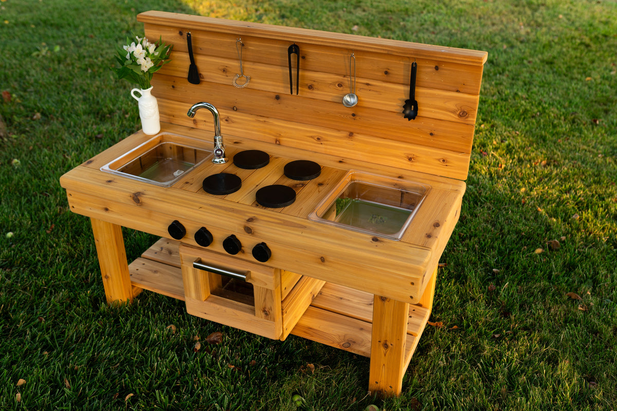 Cedar outdoor mud kitchen by Noble Wooden Toys with oven, stovetop, working faucet and 2 centred clear sinks