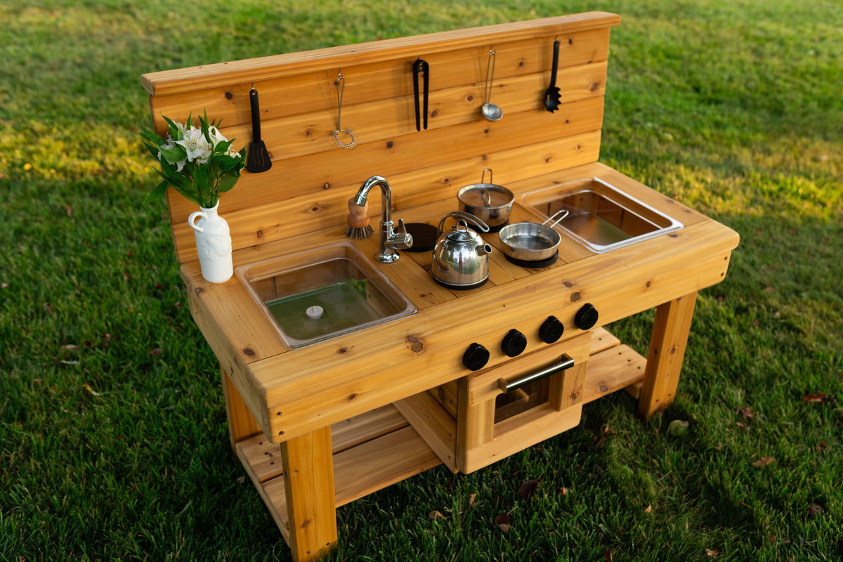 Cedar outdoor mud kitchen by Noble Wooden Toys with oven, stovetop, working faucet and 2 centred clear sinks