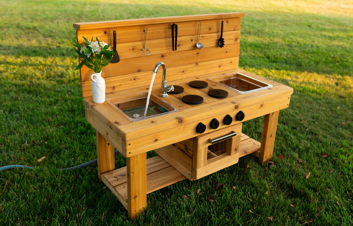 Cedar outdoor mud kitchen by Noble Wooden Toys with oven, stovetop, working faucet and 2 centred clear sinks