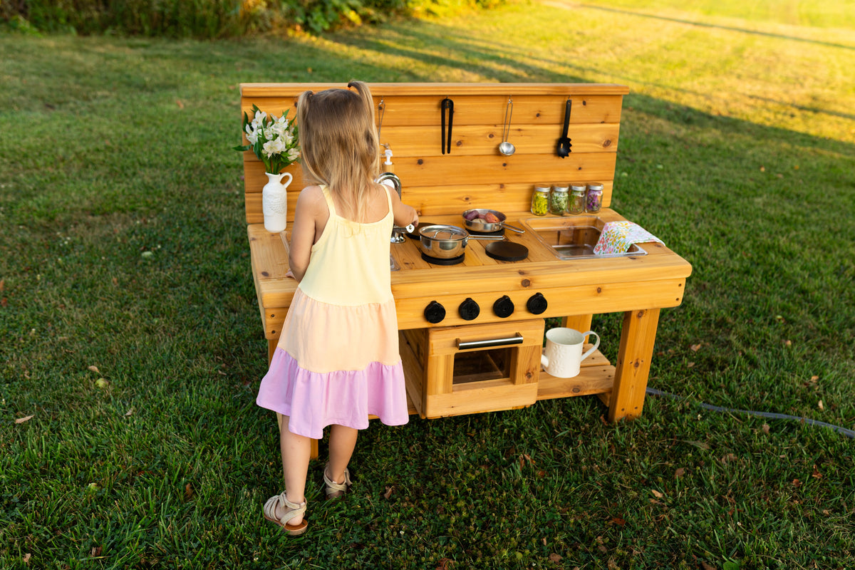 Cedar outdoor mud kitchen by Noble Wooden Toys with oven, stovetop, working faucet and 2 centred clear sinks
