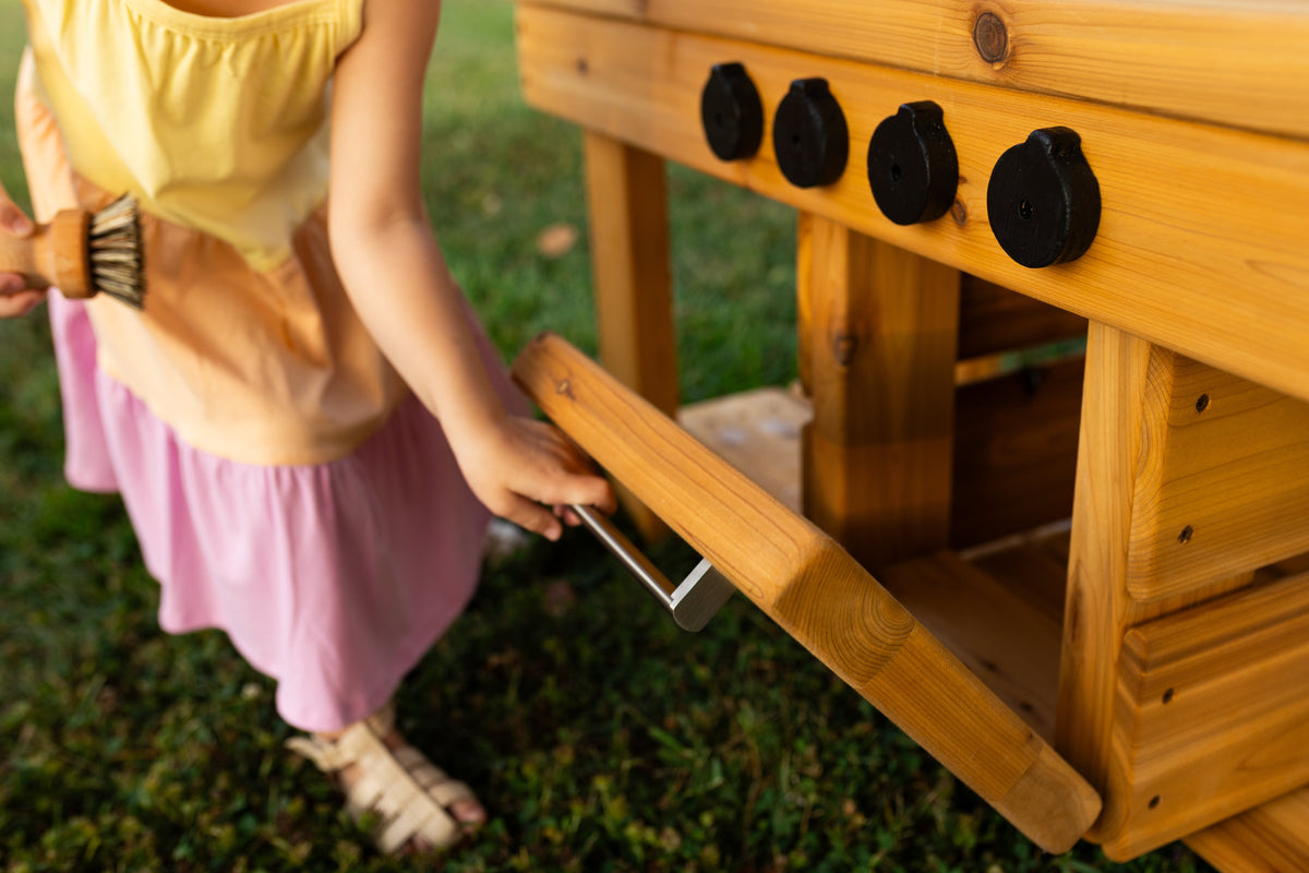Cedar outdoor mud kitchen by Noble Wooden Toys with oven, stovetop, working faucet and 2 centred clear sinks