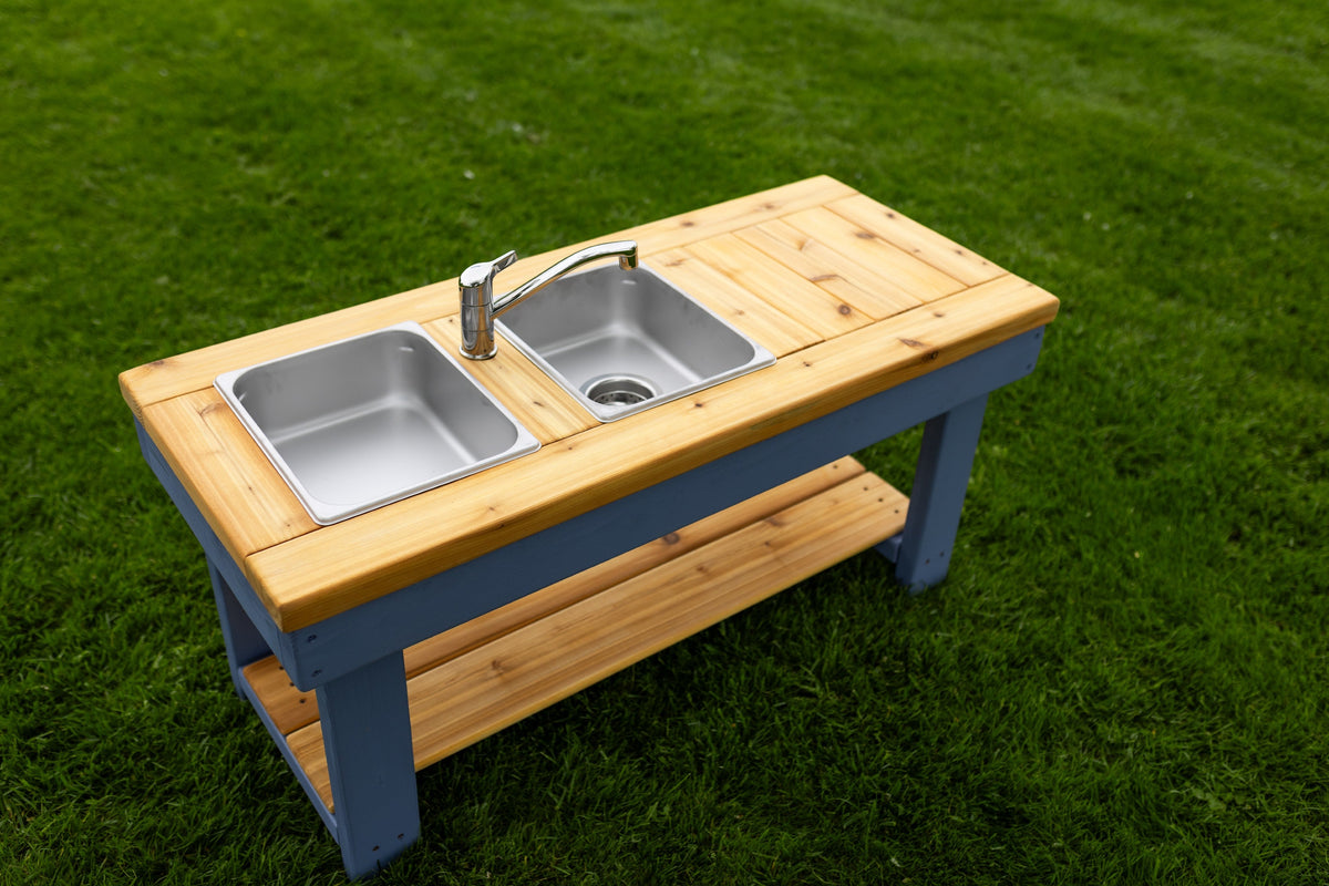 Simple painted cedar outdoor mud kitchen by Noble Wooden Toys with shelf and 2 stainless steel sinks