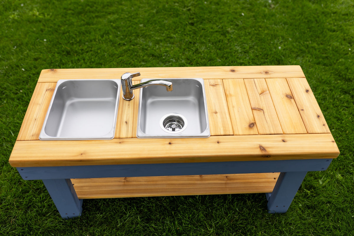 Simple painted cedar outdoor mud kitchen by Noble Wooden Toys with shelf and 2 stainless steel sinks