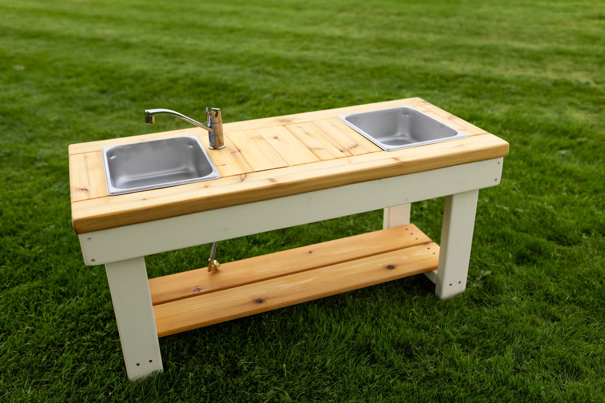 Simple painted cedar outdoor mud kitchen by Noble Wooden Toys with shelf and 2 centred stainless steel sinks