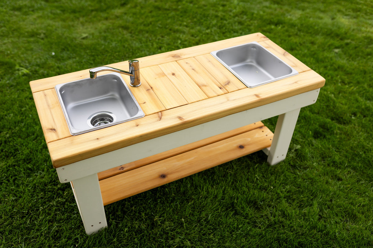 Simple painted cedar outdoor mud kitchen by Noble Wooden Toys with shelf and 2 centred stainless steel sinks