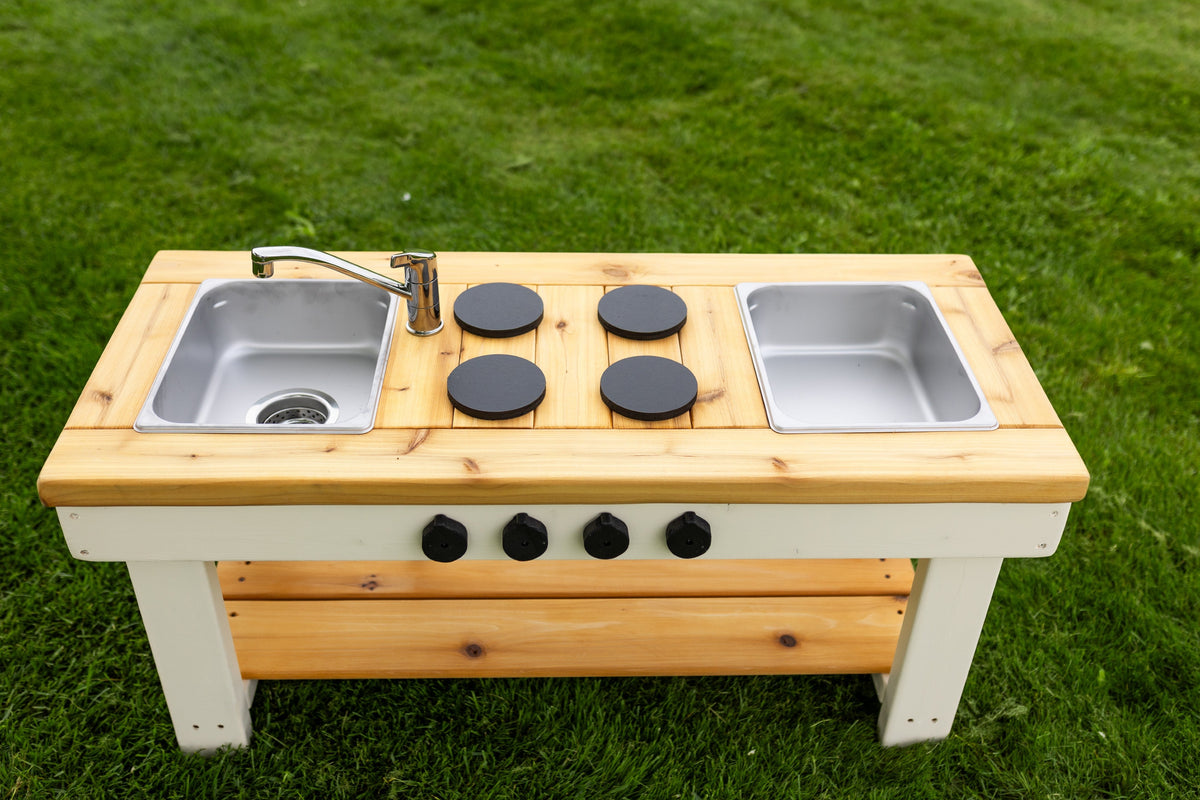 Simple painted cedar outdoor mud kitchen by Noble Wooden Toys with shelf and 2 centred stainless steel sinks