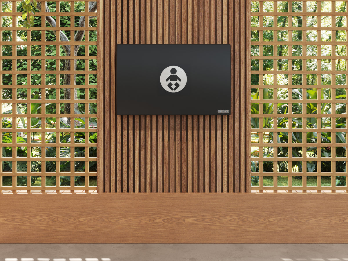 Table à langer murale Element XB avec dosseret inox noire fermée, installée au mur