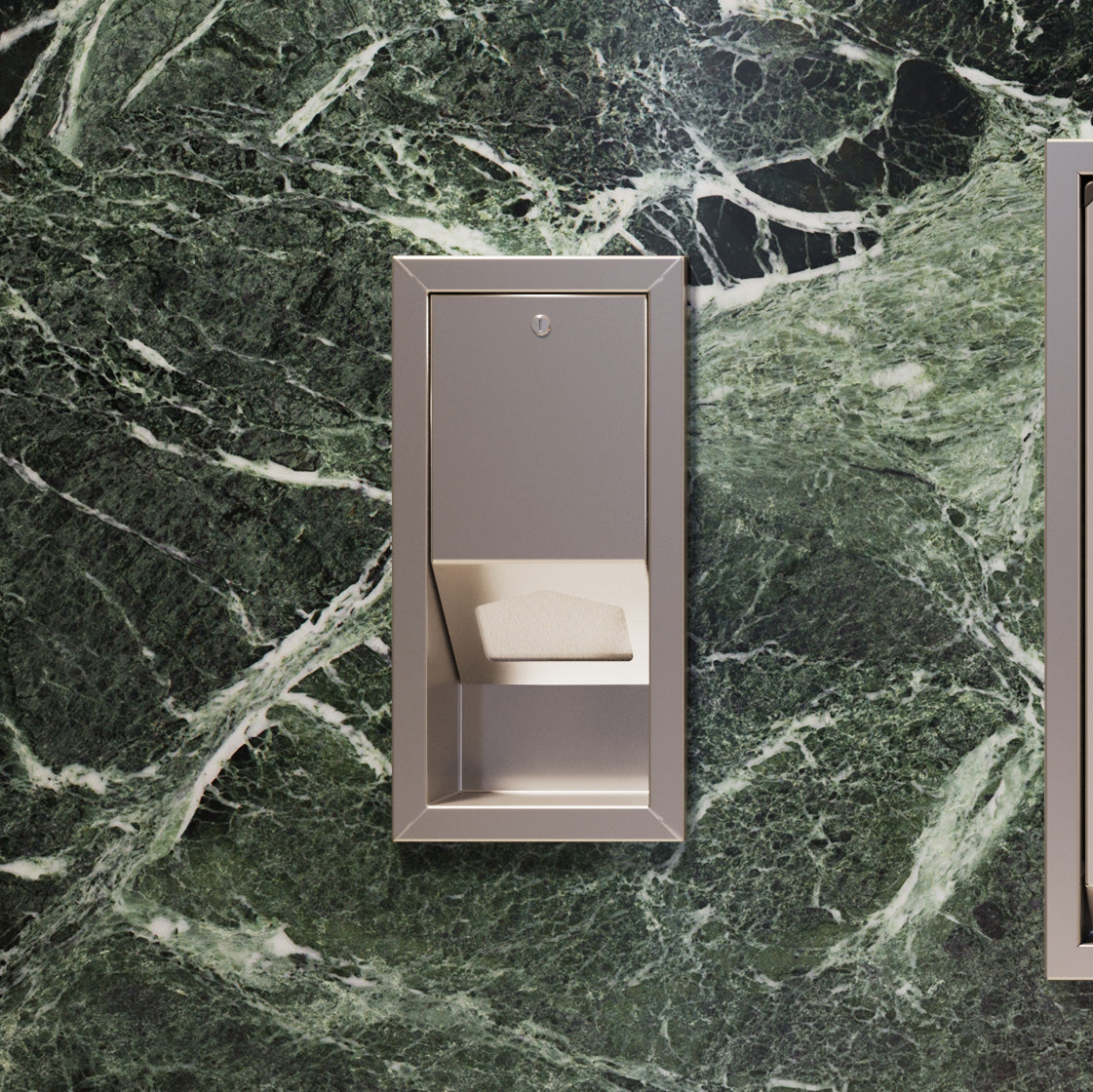 Distributeur de protège-tables encastré en inox installé dans un mur de salle de bain